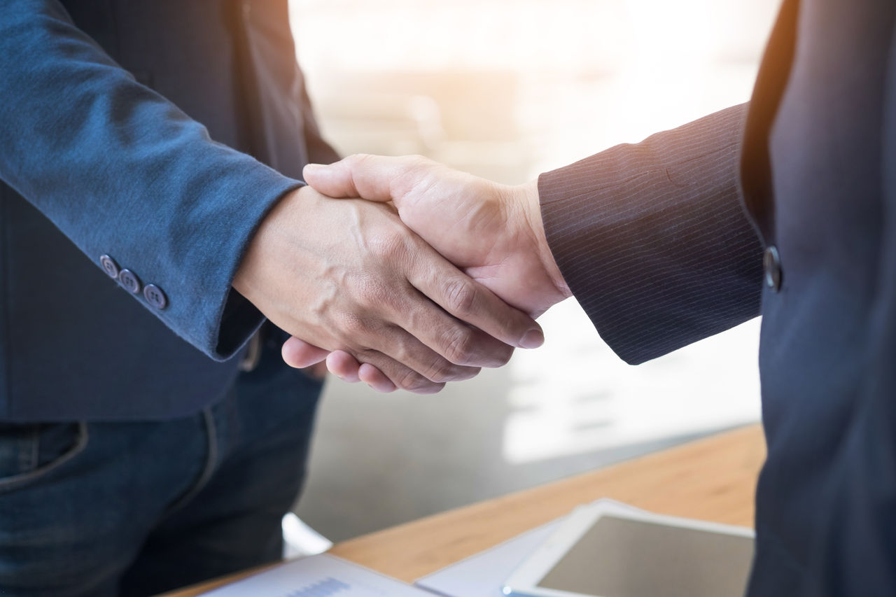 Two business man shaking hands in the office