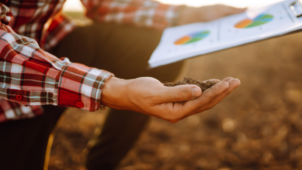Farmer's hand with clipboard 