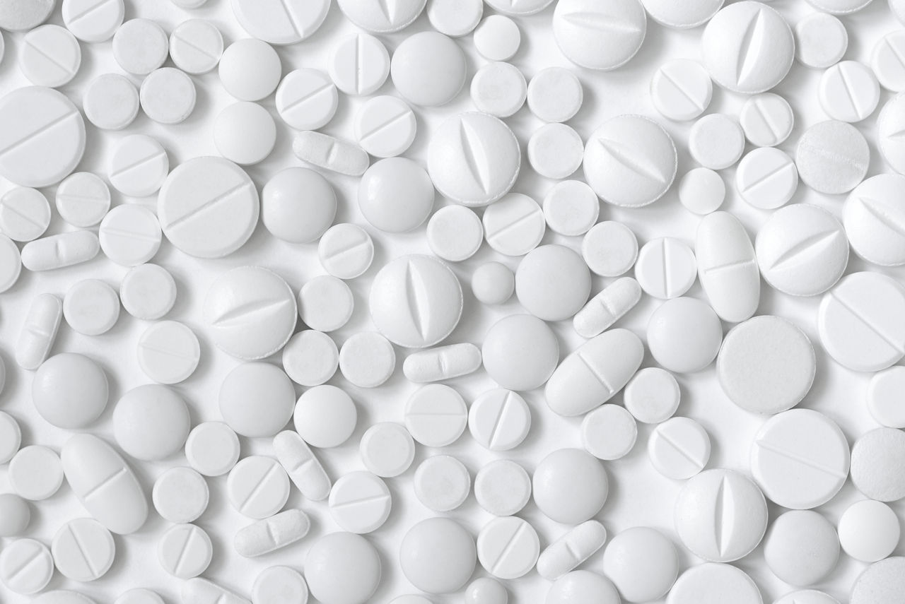 White pills, white background