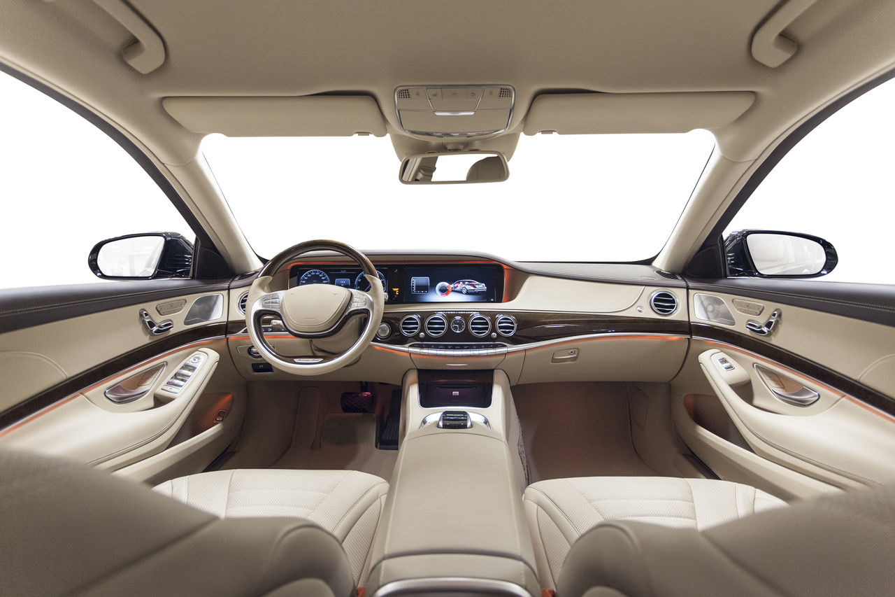Car interior luxury. Beige comfortable seats, steering wheel, dashboard, climate control, speedometer, display, wood decoration & orange ambient light; Shutterstock ID 374122960; purchase_order: GDS_Engineered materials automotive; job: ; client: ; other: 