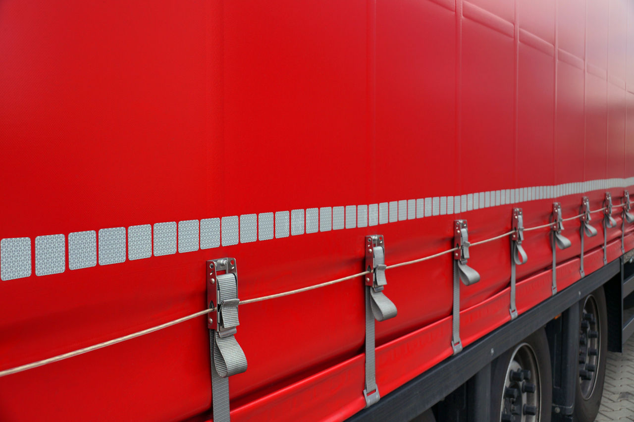 Truck transport. View of the tarpaulin covering the semi-trailer of the truck. ; Shutterstock ID 1582044088; purchase_order: POL Website Automotive_Plastisols; job: ; client: ; other: 