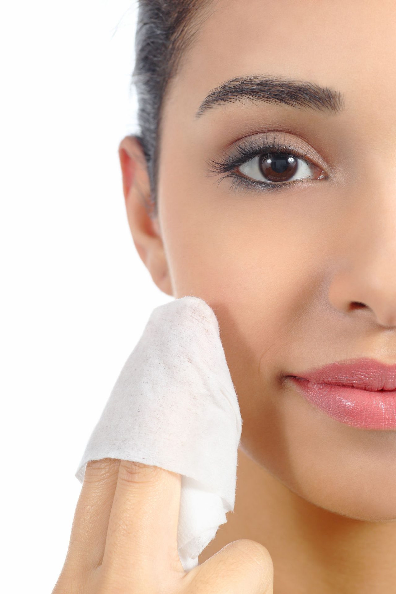 Close up of a woman face removing make up with a baby wipe isolated on a white background              ; Shutterstock ID 161645882
