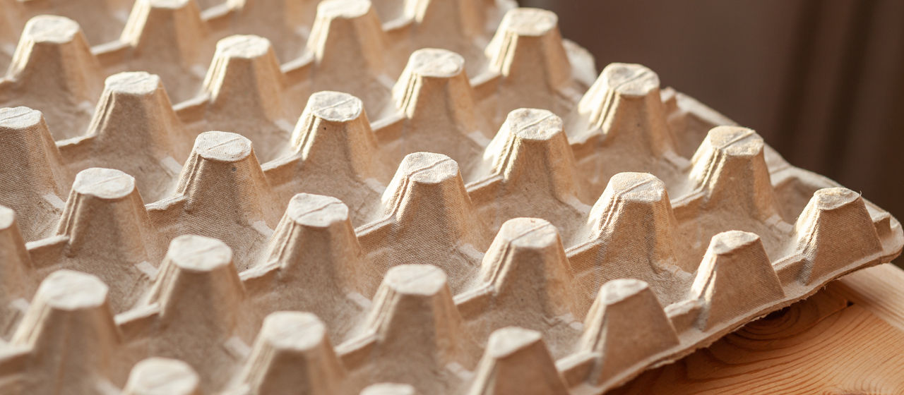 Protective cardboard packaging for storing eggs. Empty biodegradable molded egg box made of paper pulp. ; Shutterstock ID 2084604625; purchase_order: PAB; job: PAB; client: PAB; other: 