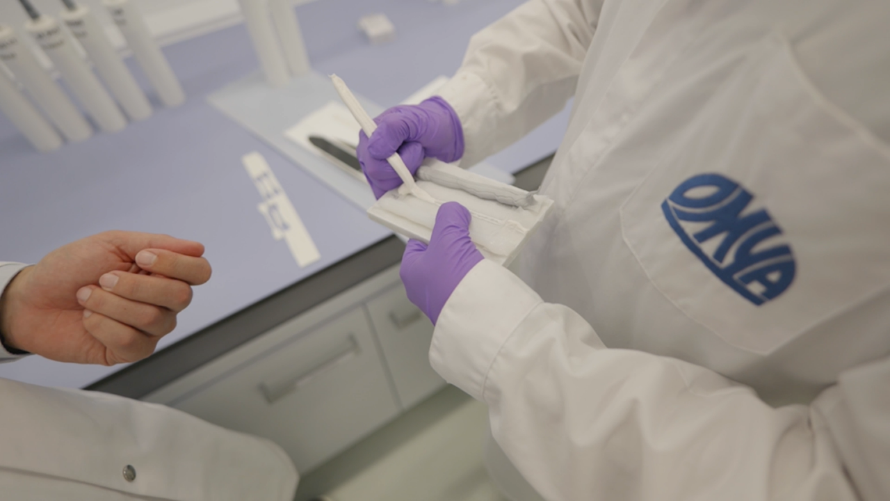 Lab technicians checking the consistency of a sealant formulation