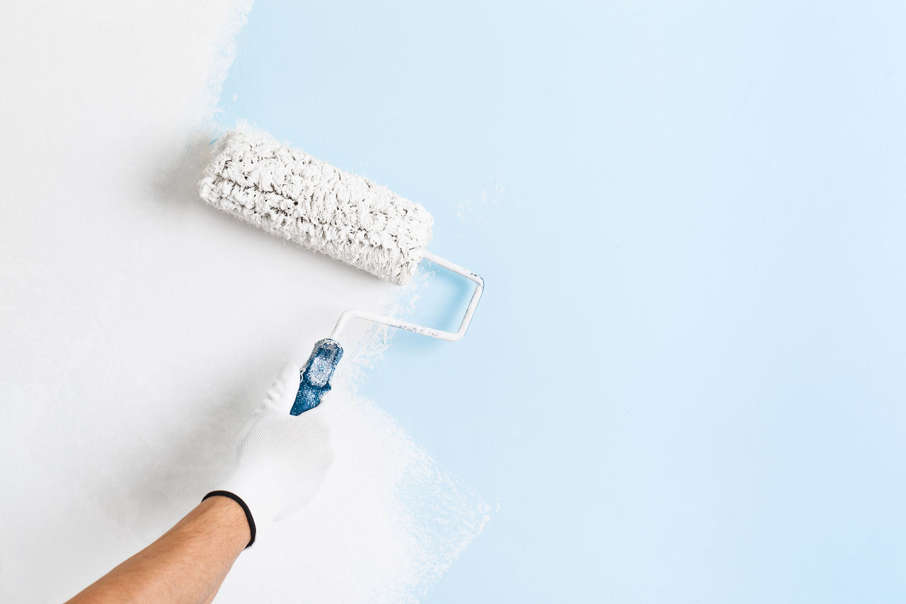 Close up of painter hand in white glove painting a wall with paint roller; copy space; Shutterstock ID 374666983; purchase_order: CON; job: P&C - Decorative paints, main applications; client: ; other: 