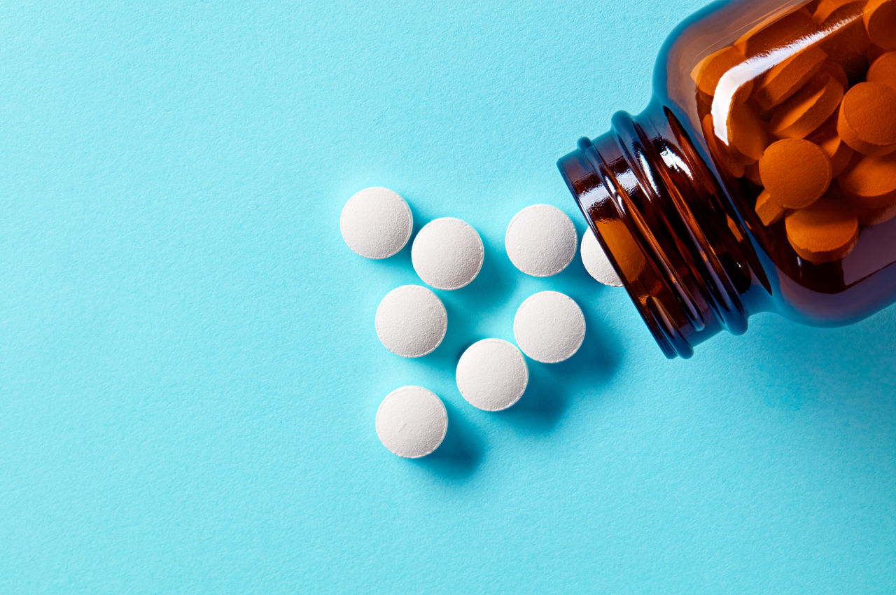 white tablets on a blue surface