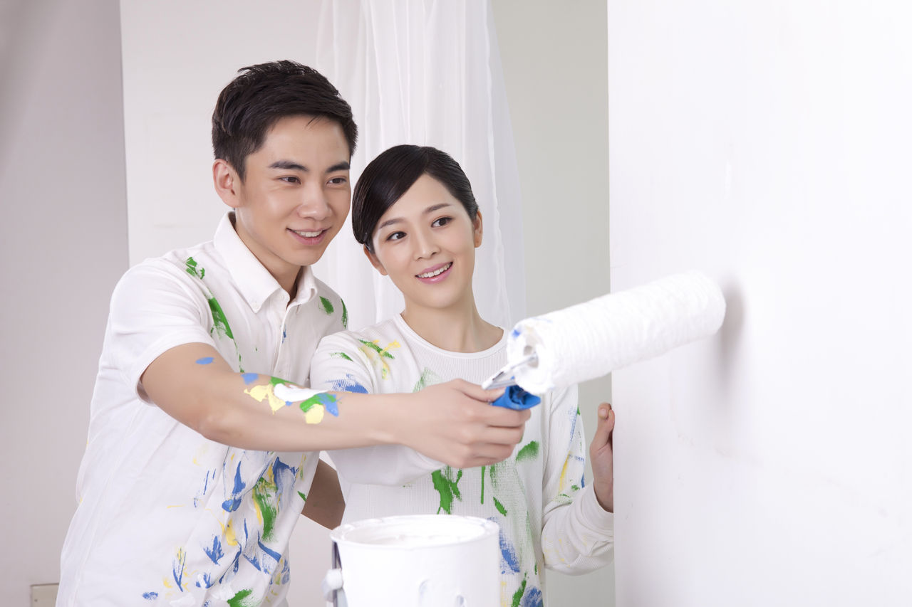 Young couple painting a wall