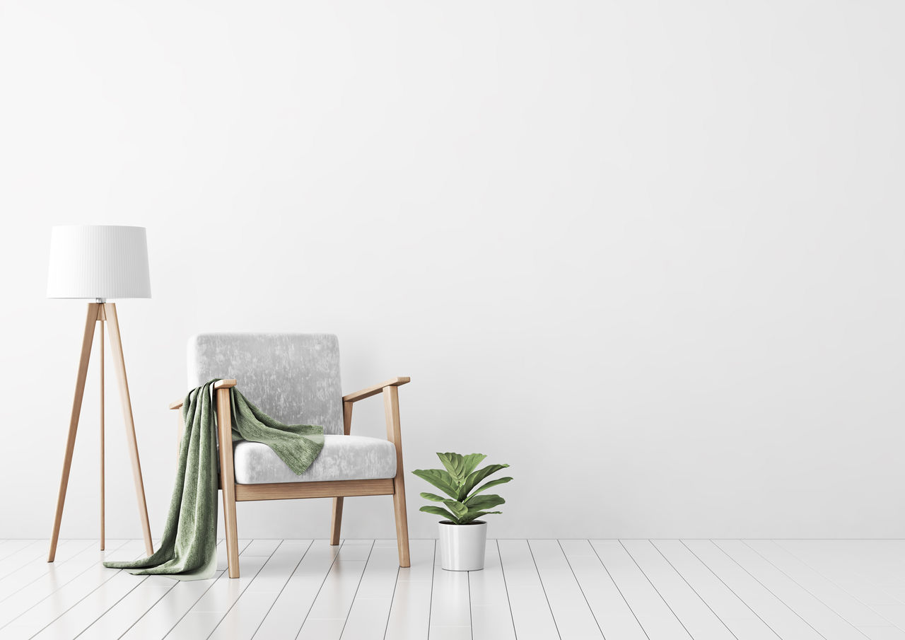 wooden_chair_and_lamp_in_front_of_white_matt_wall