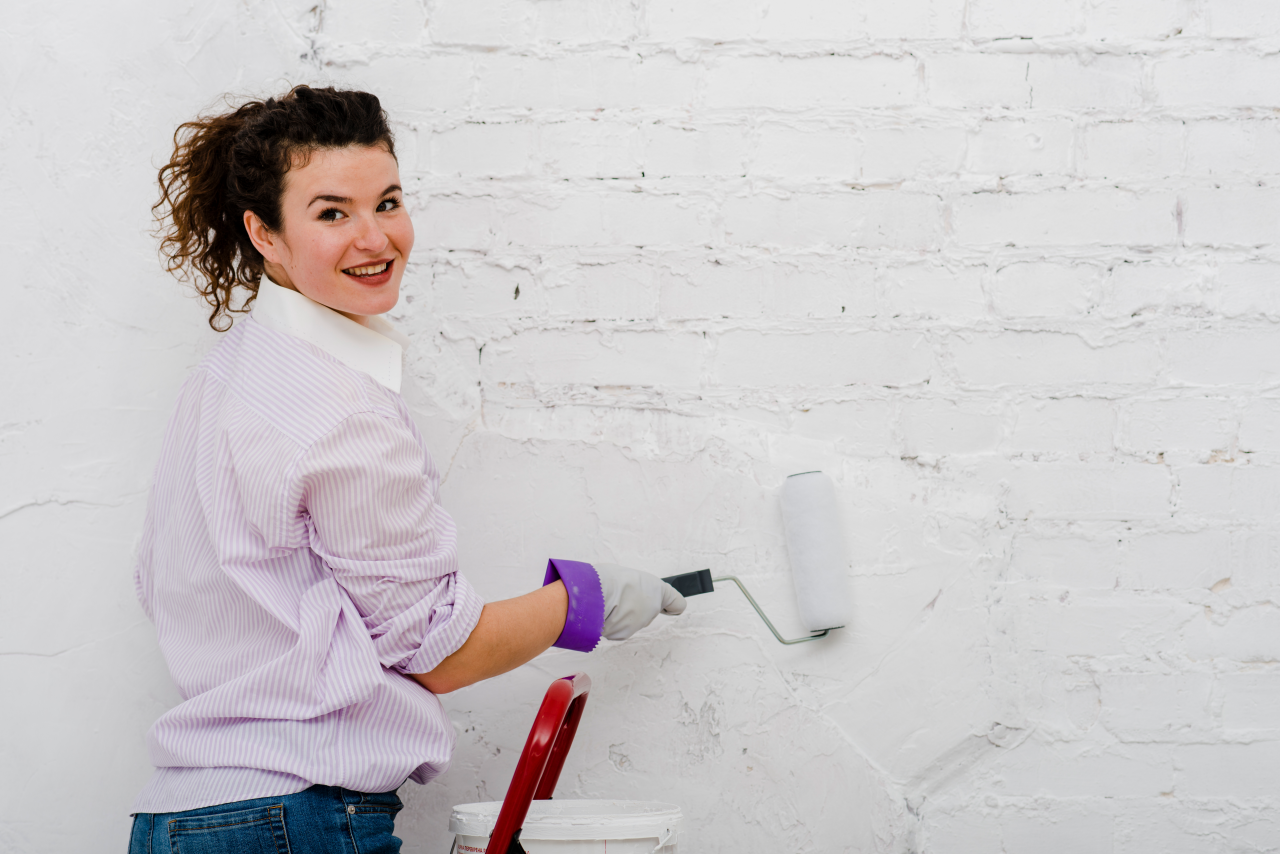 Woman painting wall