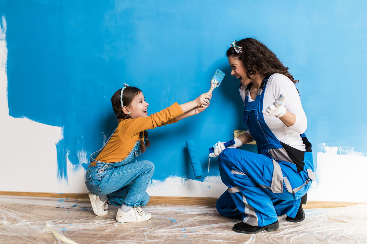 Mother and daughter enjoying together while painting wall.
1715459902