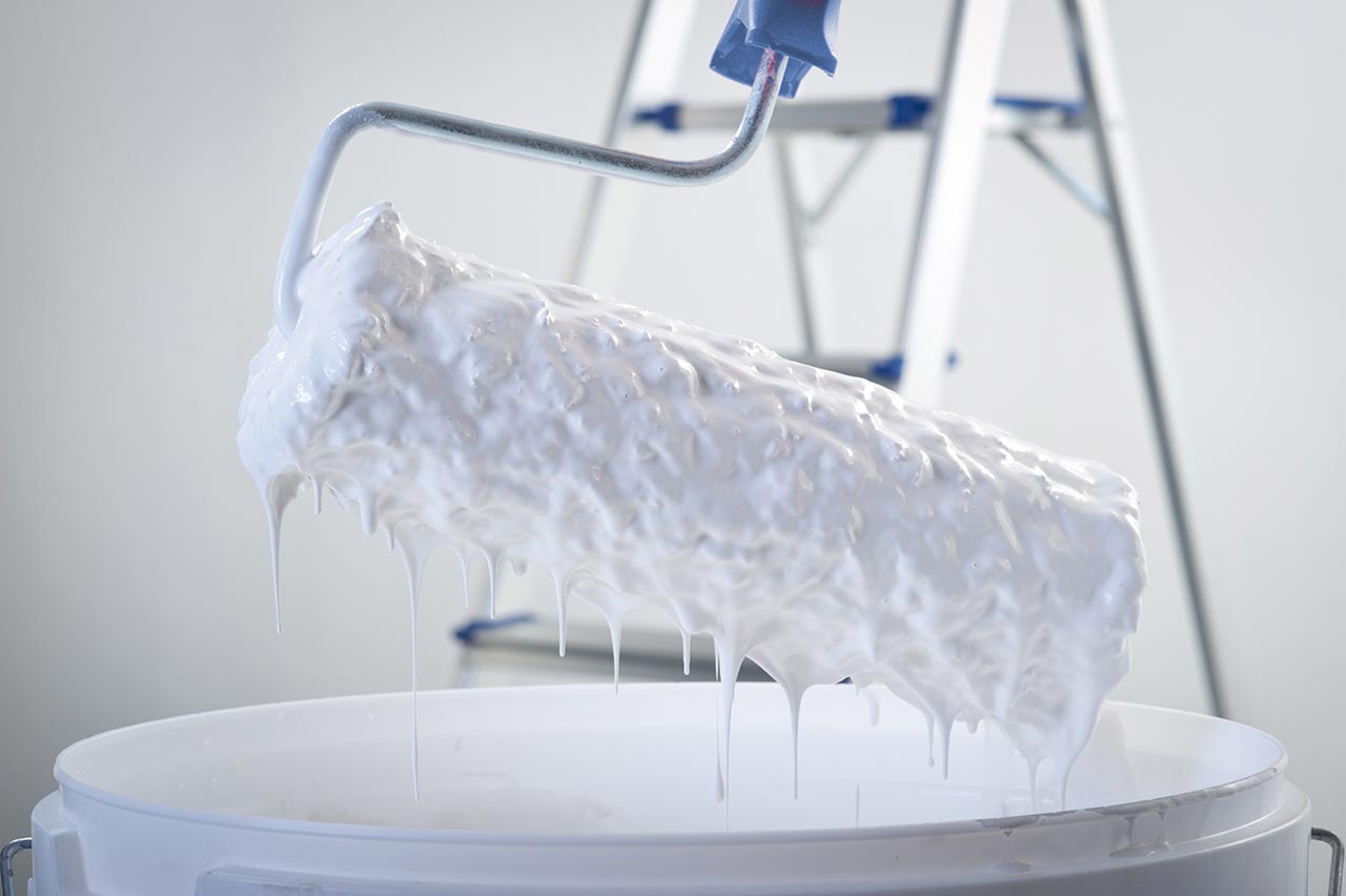 White_paint_dripping_from_roller_brush